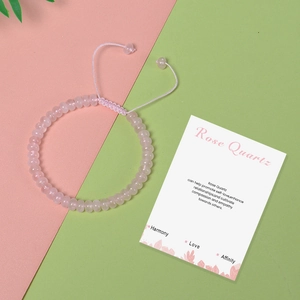Detailed view of handmade rose quartz abacus bead bracelet with adjustable woven cord