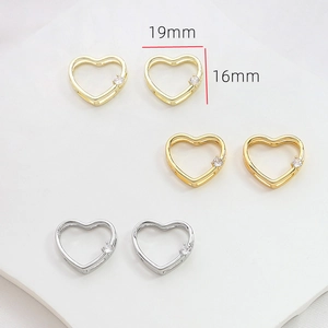 Macro detail of 19mm heart pendants in gold and silver finish with zircon stones