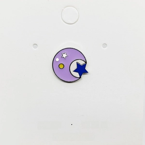 Macro view of a circular enamel moon and star pin with high-quality metal finish