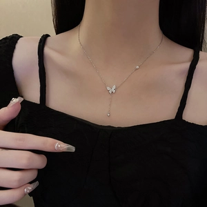 Sleek silver titanium steel butterfly necklace featuring zircon pendant on a female model