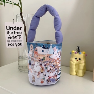 Detailed view of the winter illustration on the canvas bucket bag with purple cloud handle