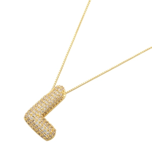 Detailed macro of gold-plated balloon letter L pendant necklace with zircon inlay