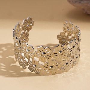 Detailed close-up of a silver floral double-layer open bangle with polished daisy patterns