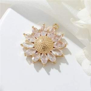 Macro view of 14k gold-plated sunflower pendant with sparkling zircon crystals