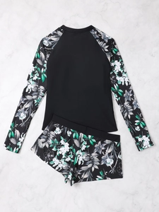 Detailed flat lay of women long sleeve rash guard with floral print on white marble