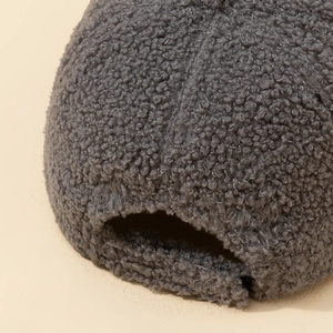 Macro detail of grey faux shearling baseball cap showing soft texture and back strap