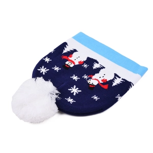 Detailed view of winter knit beanie with festive snowman pattern and soft white faux fur pompom