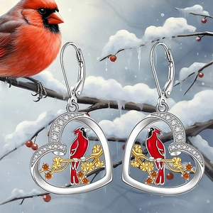 Macro detail of heart-shaped cardinal earrings with crystals and white zircons