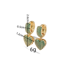 Detailed view of green zircon heart earrings with size markings 2.6cm and 1.2cm
