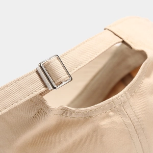 Detail view of cotton baseball cap back with silver metal buckle and adjustable strap