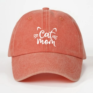 Detail of washed cotton canvas texture and Cat Mom embroidery on the orange baseball cap
