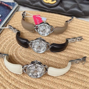 Three elegant crystal watches with leather straps in brown, black and beige colors