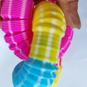 Colorful 29mm telescopic pop tube sensory toy in pink yellow and blue stripes