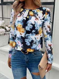 Detailed view of women's long sleeve floral print top in navy blue with yellow blossoms