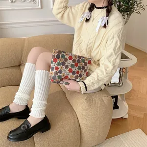 Vue détaillée du sac à maquillage en velours côtelé fleuri vintage avec étiquette tissée
