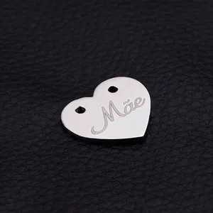 Polished heart-shaped stainless steel pendant with Mãe engraving and dual holes for jewelry
