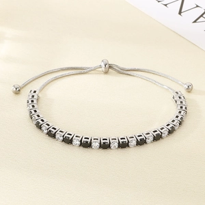 Detail of adjustable silver bracelet featuring alternating black and white round cubic zirconia