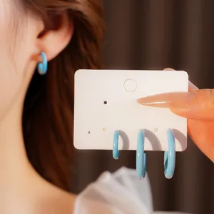 Minimalist light blue enamel C-shaped hoop earrings set in three different sizes