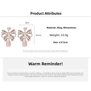 Detailed view of pink heart and bow earrings with rhinestones and teardrop charms
