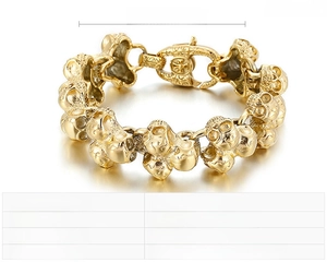 Macro detail of punk skull link bracelet in gold-tone stainless steel showing clasp