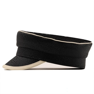 Close-up of black PU leather beret with snakeskin texture and cream piping details