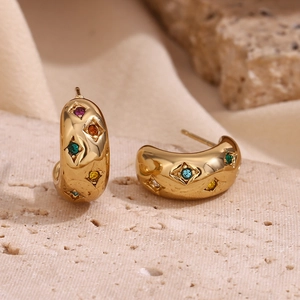 Detailed macro view of 18K gold plated C-shaped earrings with colorful zircon stars