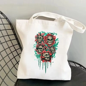 Vintage canvas tote bag with skull floral print on black metal chair for travel