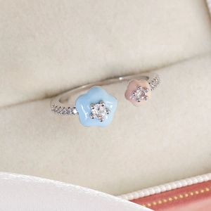 Close-up of adjustable flower ring with colorful enamel and sparkling zircons