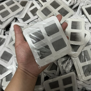 Close-up of four white square mesh screen repair patches with adhesive backing in packaging