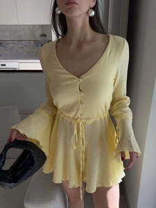 Pale yellow long sleeve V-neck mini dress with tiered ruffle sleeves and drawstring waist