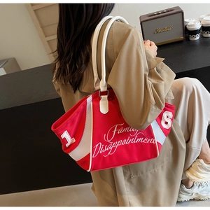 Detail of red vintage bowling bag with white embroidered text and mesh side panels