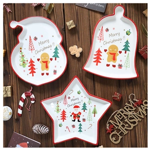 Close-up of three festive ceramic Christmas plates featuring gingerbread man and tree patterns