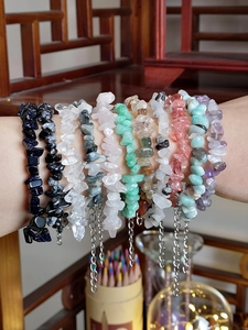 Close-up of stacked natural irregular stone bracelets with silver adjustable chains