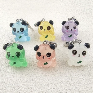 Detailed view of six colorful jelly-textured resin panda keychains in various soft pastel tones