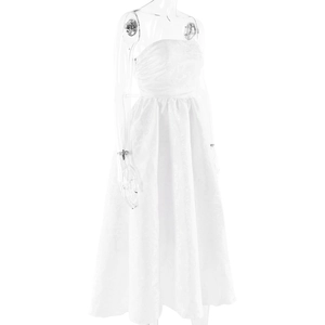 Detailed close-up of white jacquard fabric on a strapless A-line cocktail dress