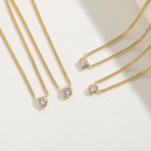 Minimalist gold necklaces with heart, round, square, and teardrop zircon pendants