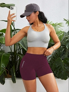 Detailansicht der High-Waist-Sportshorts mit GYMWEAR-Schriftzug und grauem Sport-BH