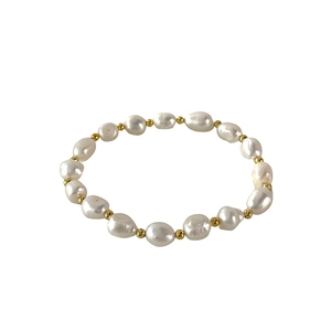 Minimalist freshwater baroque pearl bracelet with gold beads on a clean white background