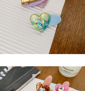 Detail showing candy-colored heart gemstone hair clips with acrylic acetate texture