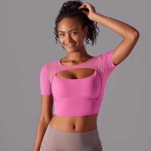 Detail of pink mesh patchwork sports top and high-waist yoga pants on professional model