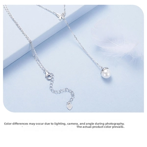 Detailed macro view of S925 silver butterfly necklace with white pearl drop pendant