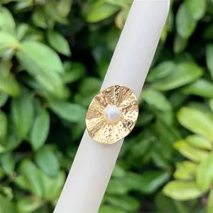Close-up of 18K gold plated hammered ring featuring a white pearl in a vintage style