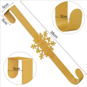 Detail of a 38cm gold metal snowflake wreath hanger with dimension markings