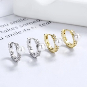 Detailed macro view of S925 sterling silver pearl hoop earrings in silver and gold finish