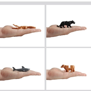 Miniature animal puzzle blocks including crocodile and shark held in hand for size