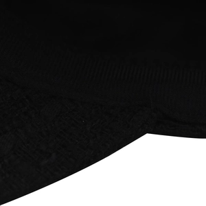 Close-up of the black knitted fabric texture and detailed stitching on the visor brim
