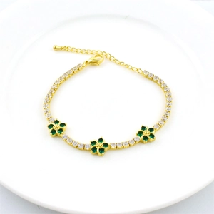 Adjustable gold chain bracelet featuring white zirconias and three green floral charms