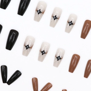Glossy amber and black checkered long ballerina press-on nails set on white background