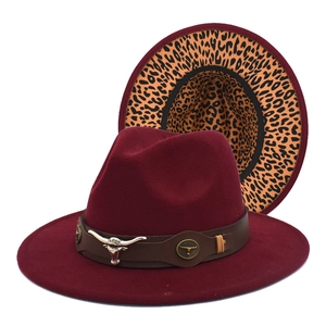 Detail of burgundy wool fedora with leopard print brim and leather bull head band