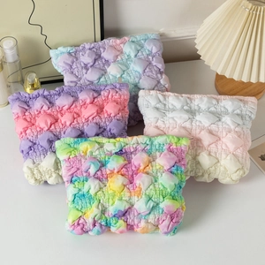 Bubble textured cloud makeup bag in rainbow and pastel gradients with top zipper closure